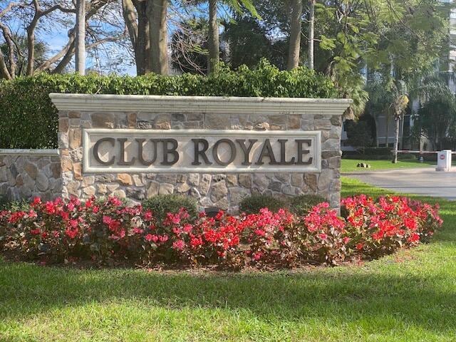 community sign featuring a lawn