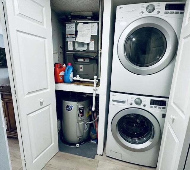 laundry room featuring stacked washer and dryer and a textured ceiling