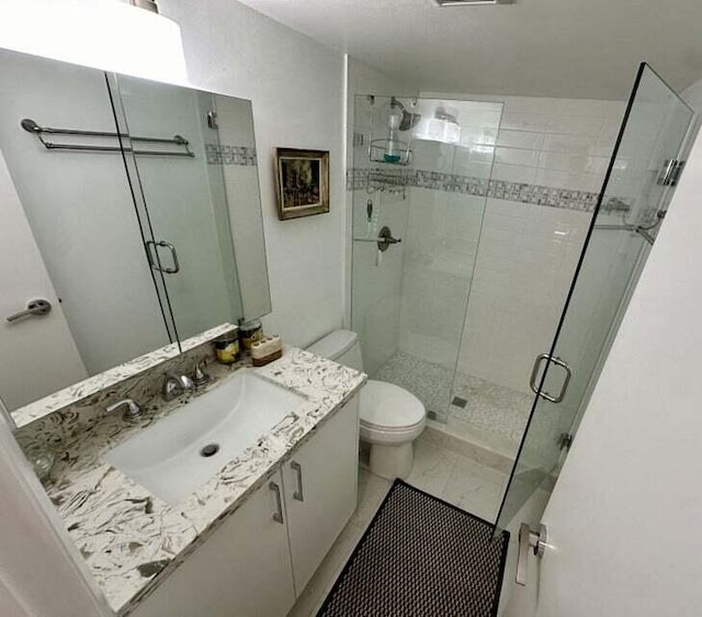 bathroom with vanity, toilet, and walk in shower