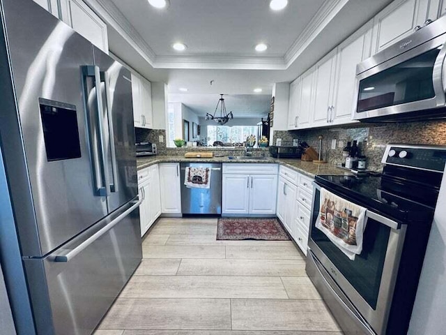 kitchen featuring kitchen peninsula, light wood-type flooring, white cabinetry, and stainless steel appliances