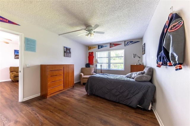 bedroom with dark wood-style floors, a ceiling fan, baseboards, and a textured ceiling