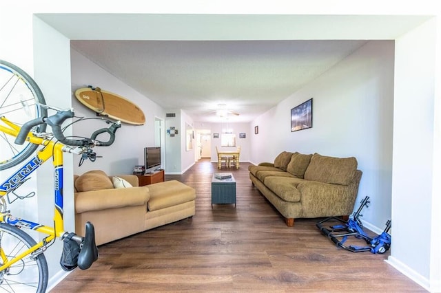 living room with baseboards and wood finished floors