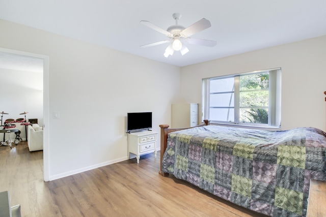 bedroom with ceiling fan and light hardwood / wood-style floors