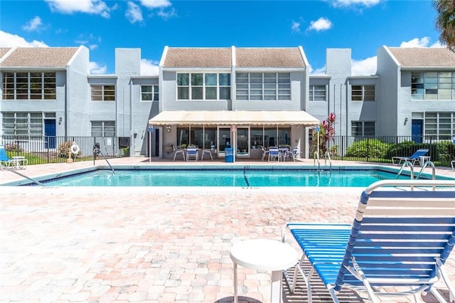 pool featuring a patio area and fence