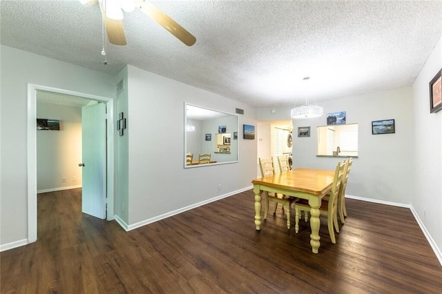 dining room with a textured ceiling, wood finished floors, visible vents, and baseboards