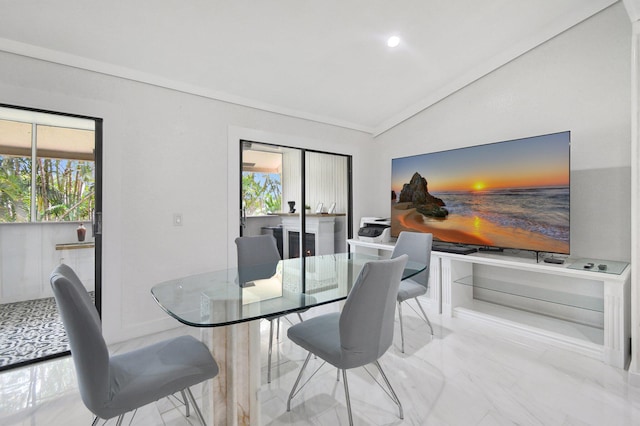 dining area featuring plenty of natural light and vaulted ceiling