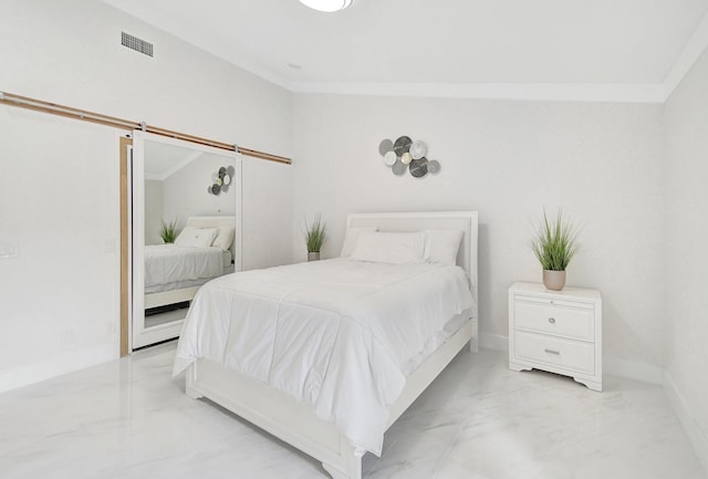 bedroom with a barn door, ornamental molding, and vaulted ceiling