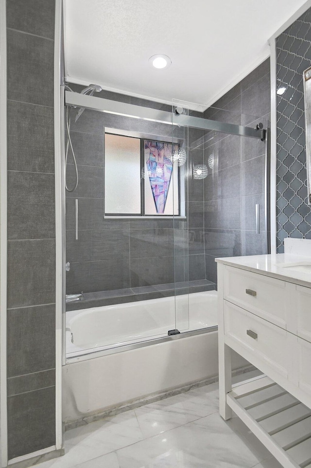 bathroom with shower / bath combination with glass door and vanity