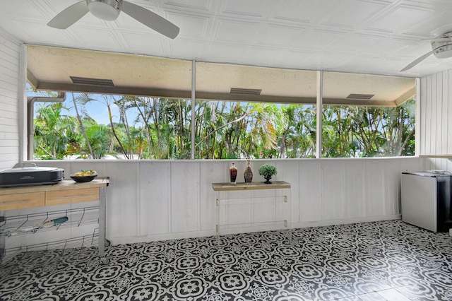 sunroom featuring ceiling fan