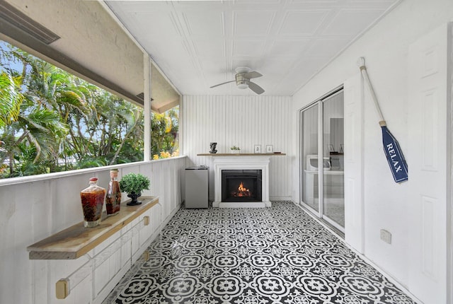 sunroom / solarium featuring ceiling fan