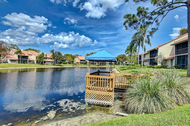 view of dock with a gazebo and a deck with water view