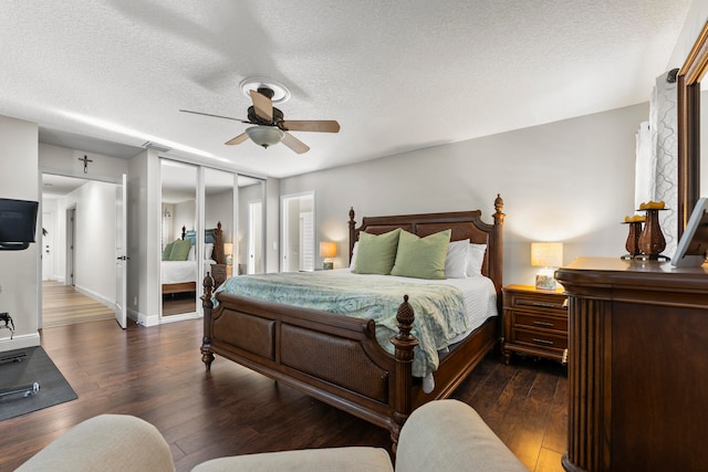 bedroom with connected bathroom, ceiling fan, dark hardwood / wood-style flooring, and multiple windows