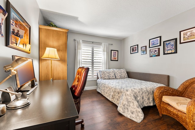 bedroom featuring dark hardwood / wood-style flooring, a closet, and a textured ceiling