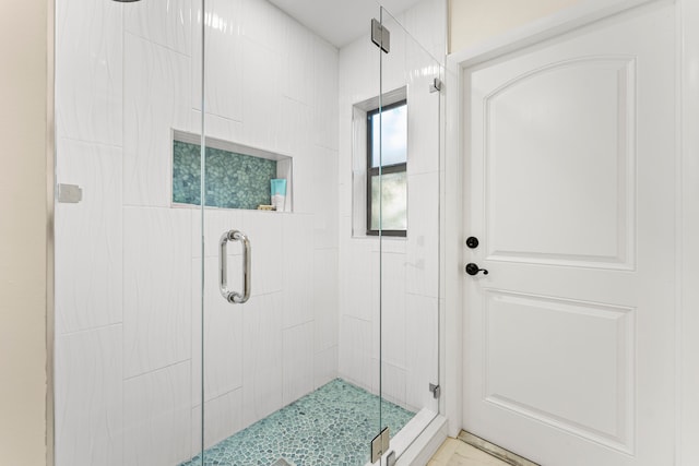 bathroom featuring vanity, toilet, and a shower with shower door