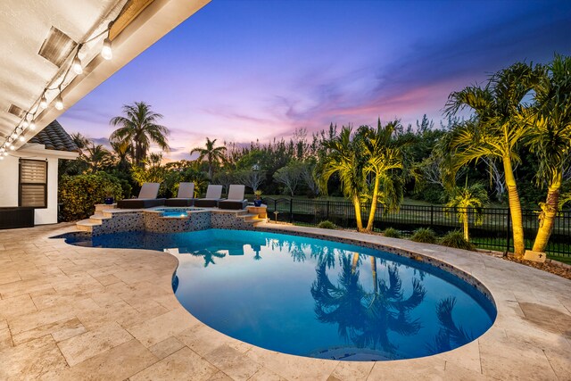 view of pool with an in ground hot tub, a yard, and a water view