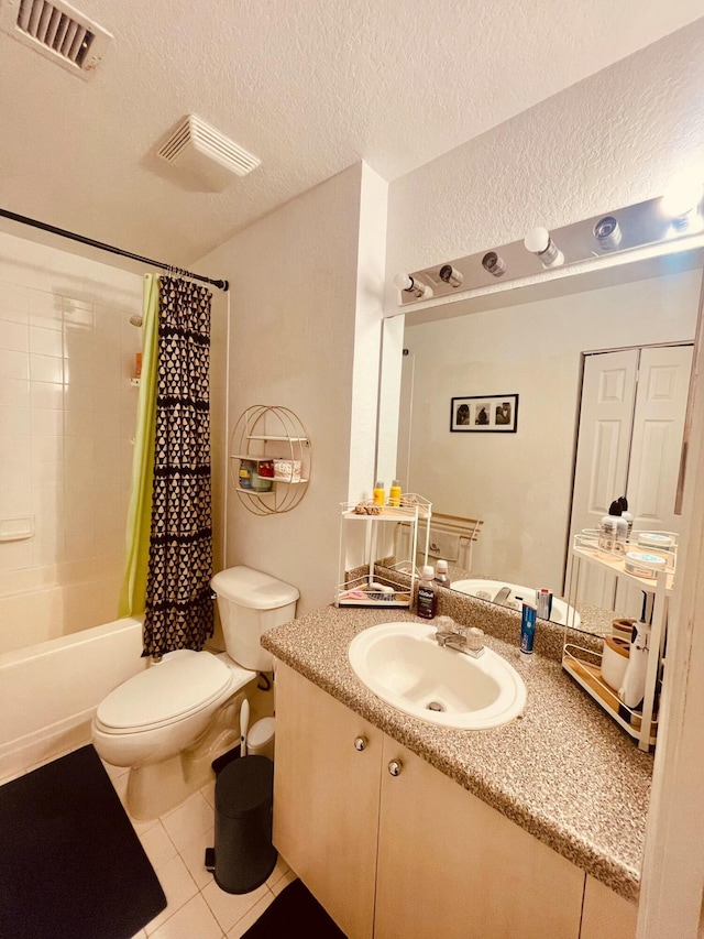 full bathroom with tile patterned floors, toilet, shower / tub combo, a textured ceiling, and vanity