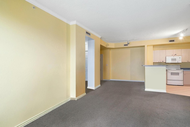 kitchen featuring visible vents, ornamental molding, a textured ceiling, white appliances, and carpet