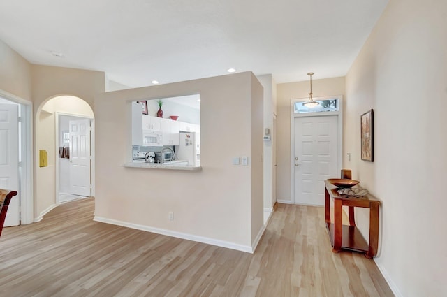 entryway with light hardwood / wood-style floors