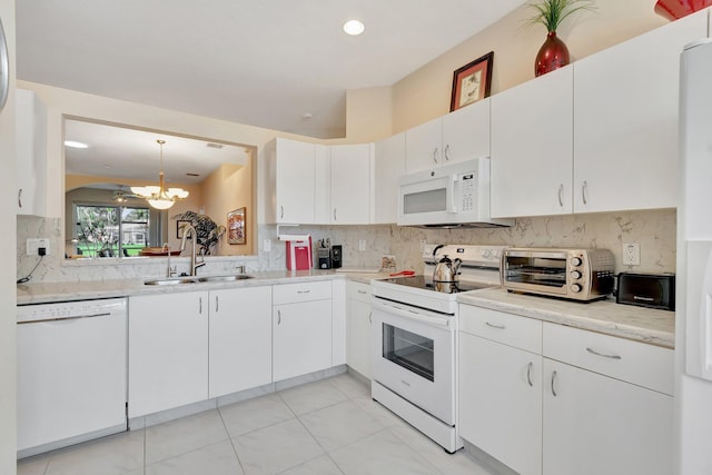 kitchen featuring sink, white cabinetry, decorative light fixtures, white appliances, and decorative backsplash