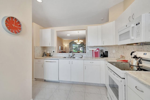 kitchen with sink, pendant lighting, white cabinets, and white appliances