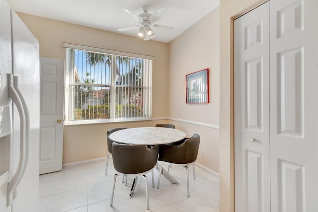 tiled dining space featuring ceiling fan