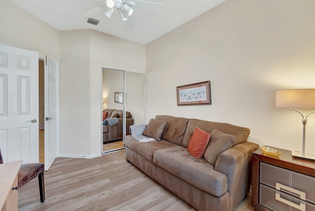 living room featuring ceiling fan and light hardwood / wood-style flooring