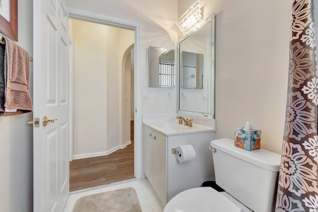 bathroom featuring vanity, tile patterned floors, and toilet