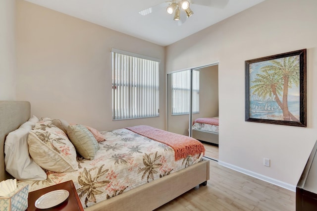 bedroom featuring light hardwood / wood-style floors, a closet, and ceiling fan