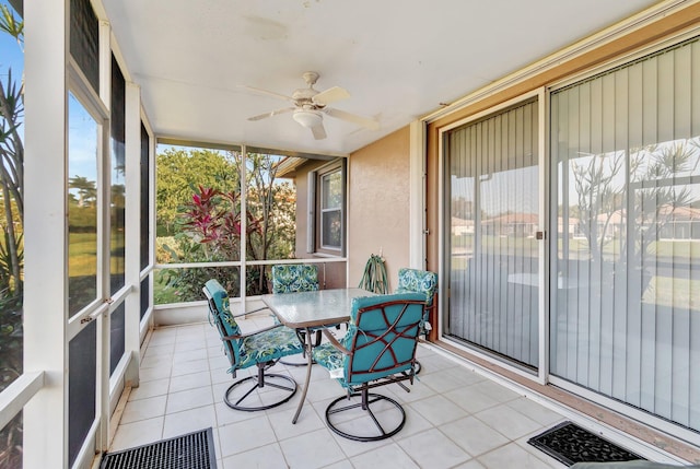 sunroom featuring ceiling fan