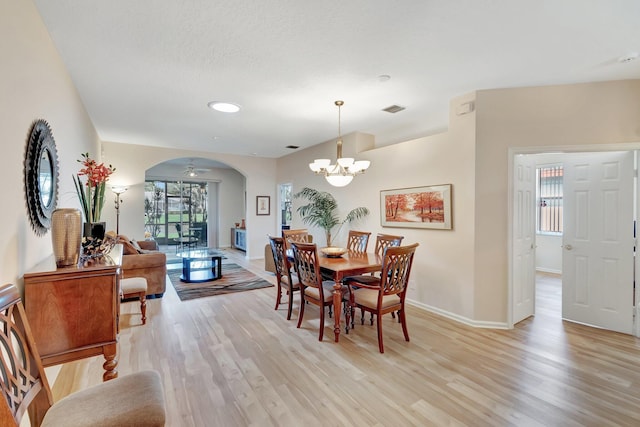 dining area featuring an inviting chandelier and light hardwood / wood-style flooring