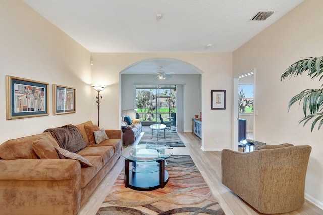 living room with ceiling fan and light hardwood / wood-style floors