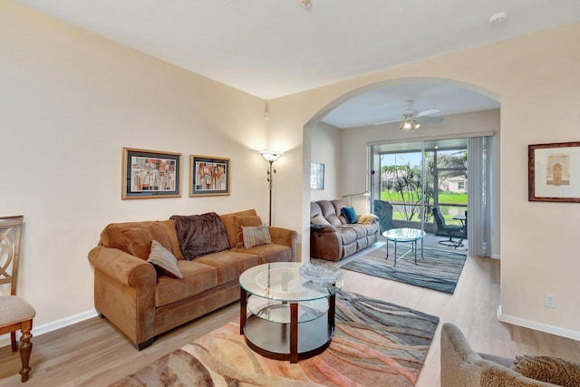 living room with light hardwood / wood-style floors and ceiling fan