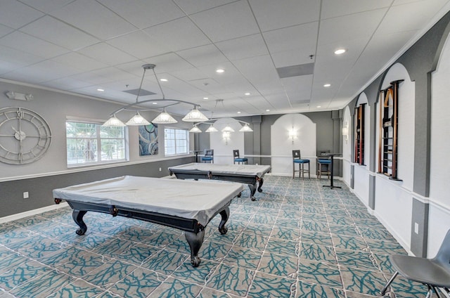 game room featuring a drop ceiling, pool table, ornamental molding, and carpet flooring