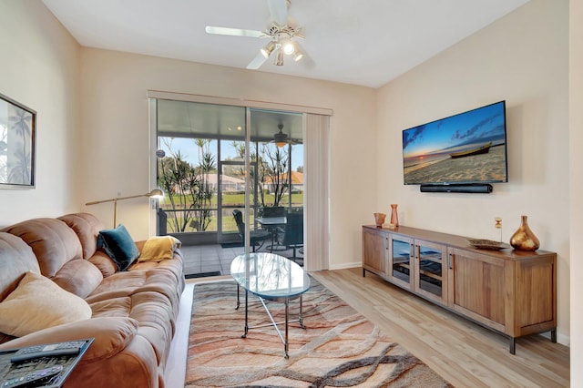 living room with ceiling fan and light hardwood / wood-style floors