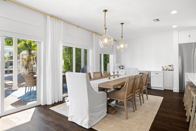 dining area featuring dark wood-type flooring and beverage cooler