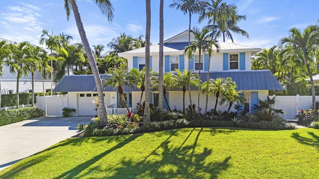 view of front of property featuring a garage and a front lawn