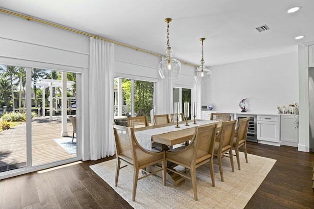 dining room featuring dark hardwood / wood-style flooring and beverage cooler