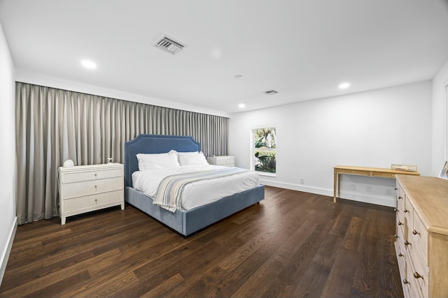 bedroom with dark wood-type flooring