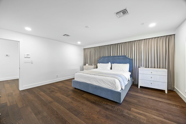 bedroom with dark wood-type flooring