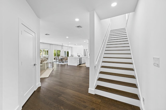 staircase featuring wood-type flooring