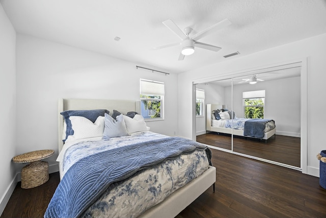 bedroom with ceiling fan, dark hardwood / wood-style floors, and a closet