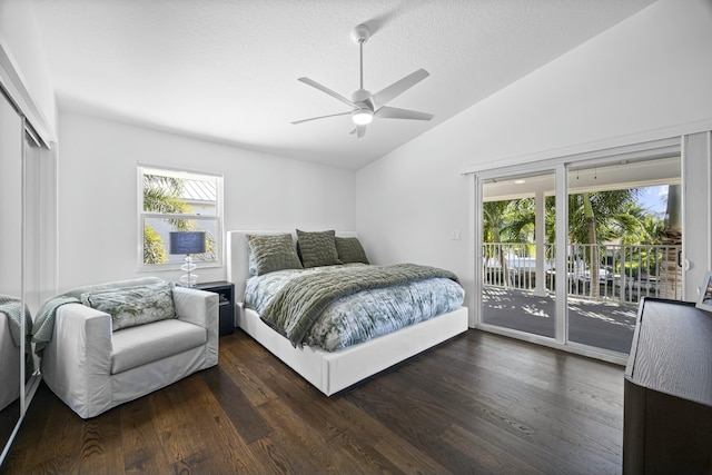 bedroom featuring ceiling fan, dark hardwood / wood-style flooring, lofted ceiling, and access to outside