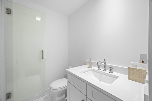 bathroom with an enclosed shower, vanity, toilet, and tile patterned floors