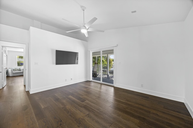 empty room with ceiling fan, dark wood-type flooring, and vaulted ceiling