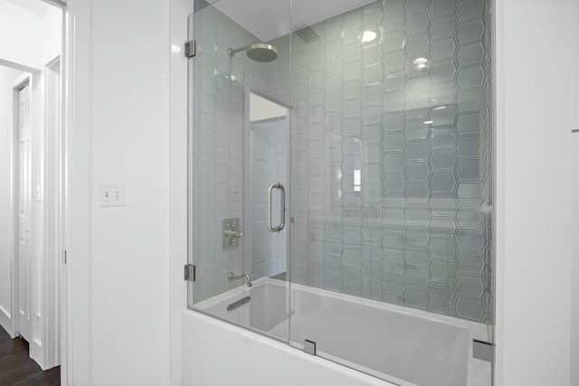 bathroom with combined bath / shower with glass door and hardwood / wood-style flooring