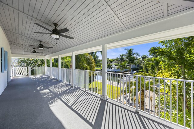 view of patio / terrace with ceiling fan, a balcony, and a water view