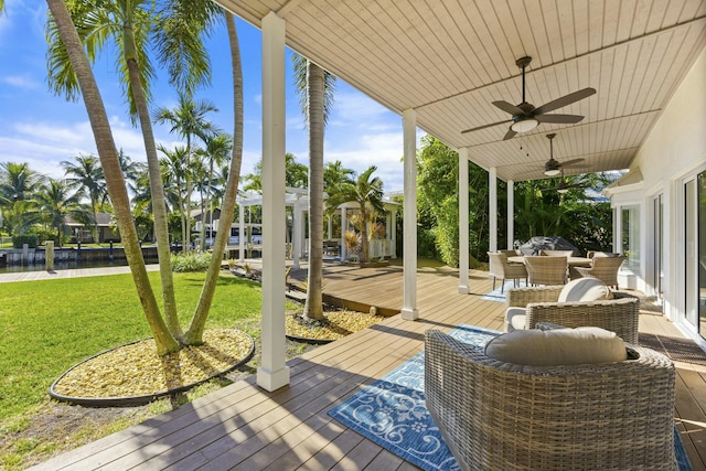 deck featuring ceiling fan and a yard