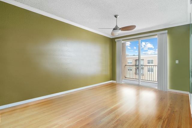 unfurnished room featuring light wood-style floors, crown molding, baseboards, and a ceiling fan