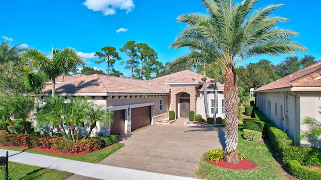 mediterranean / spanish-style home featuring a garage