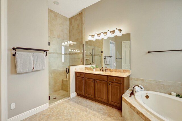 bathroom with tile patterned floors, vanity, and independent shower and bath